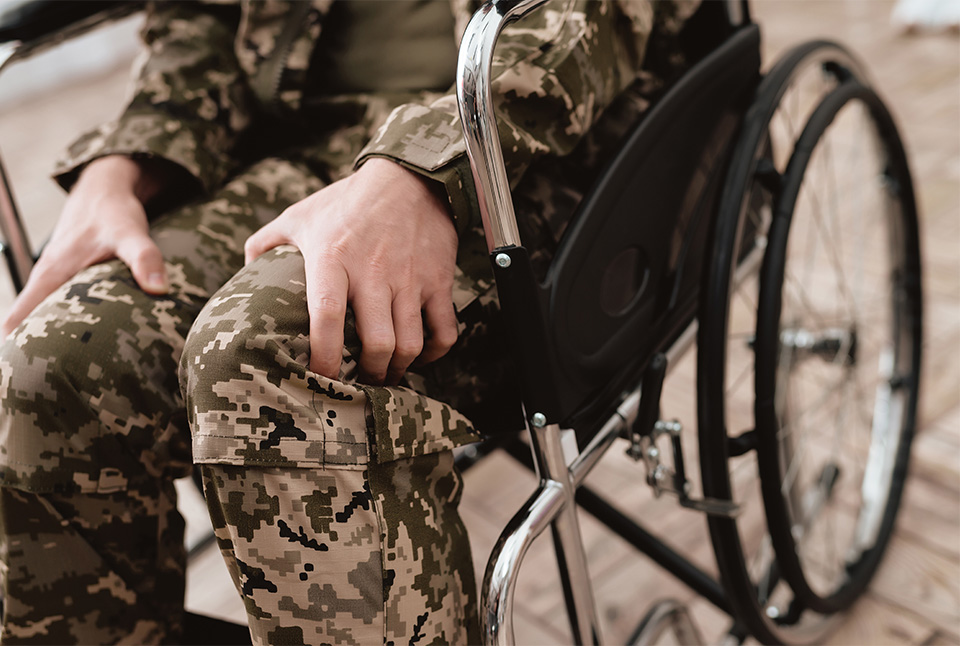 veteran with cane in wheelchair